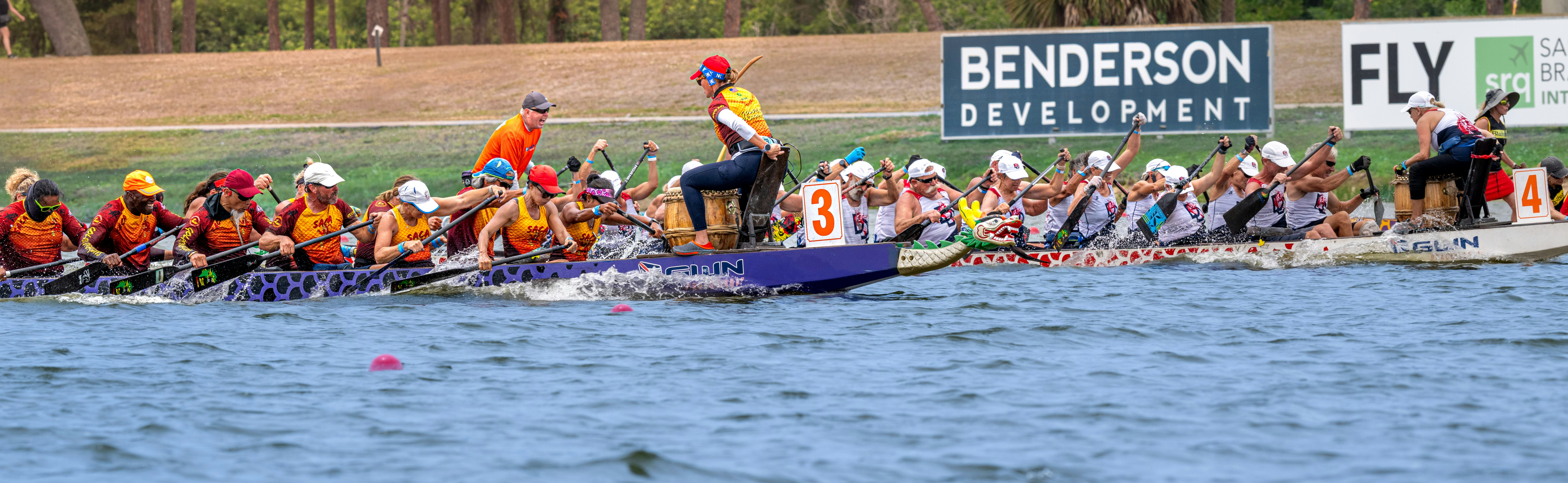 Dragon boats are racing on the water.