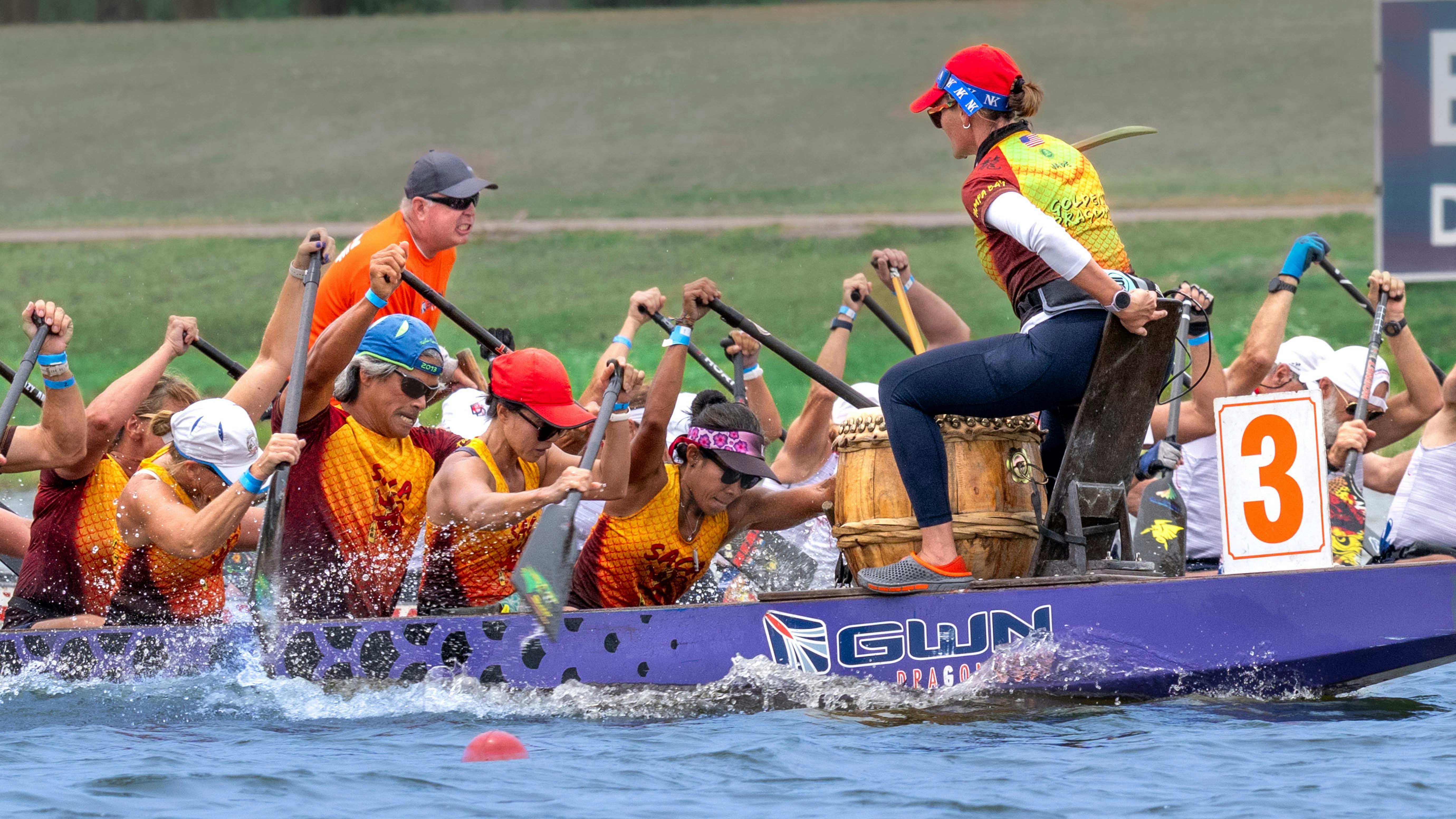 A dragon boat team races on the water.