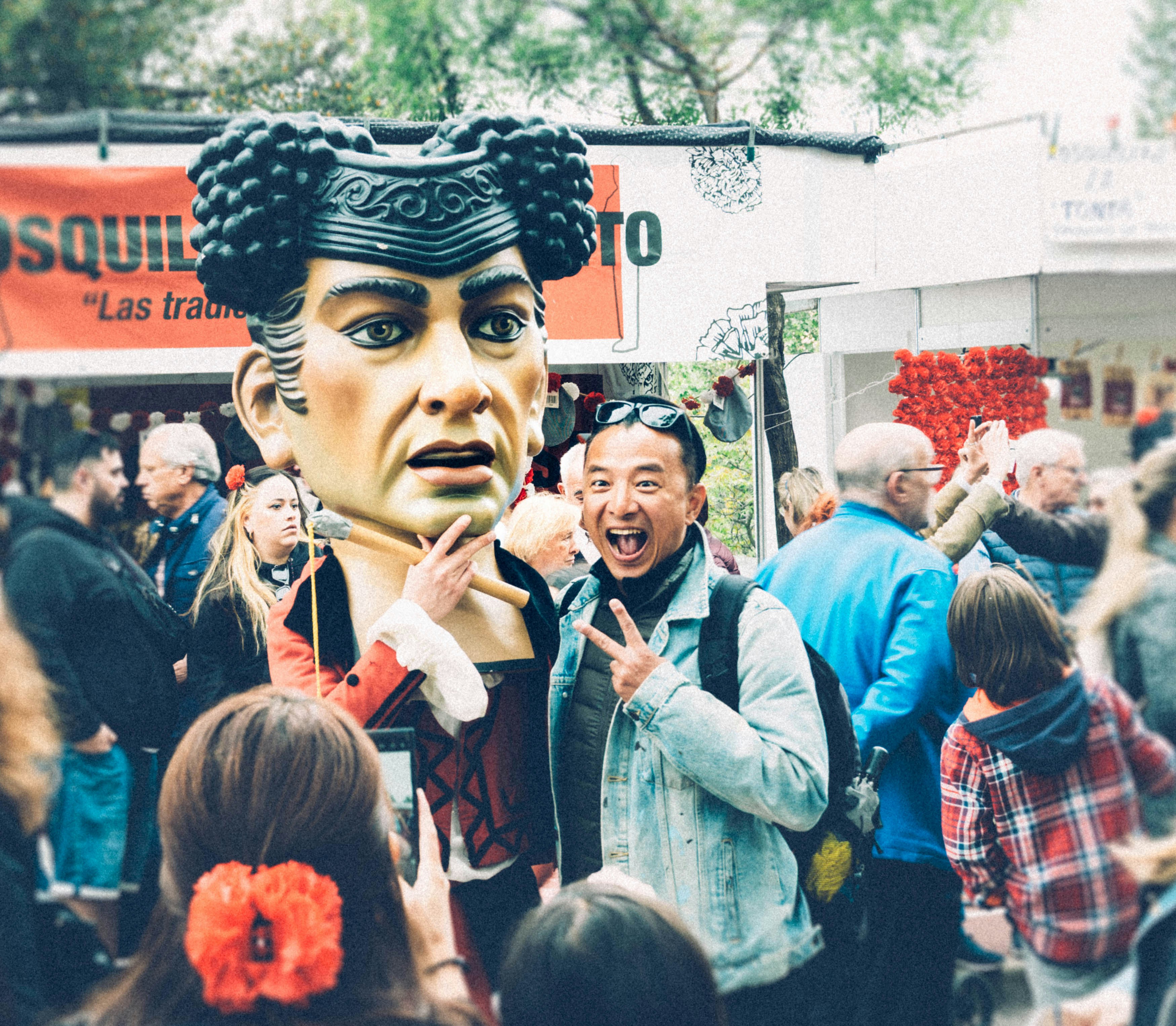 A man poses with a giant figure.
