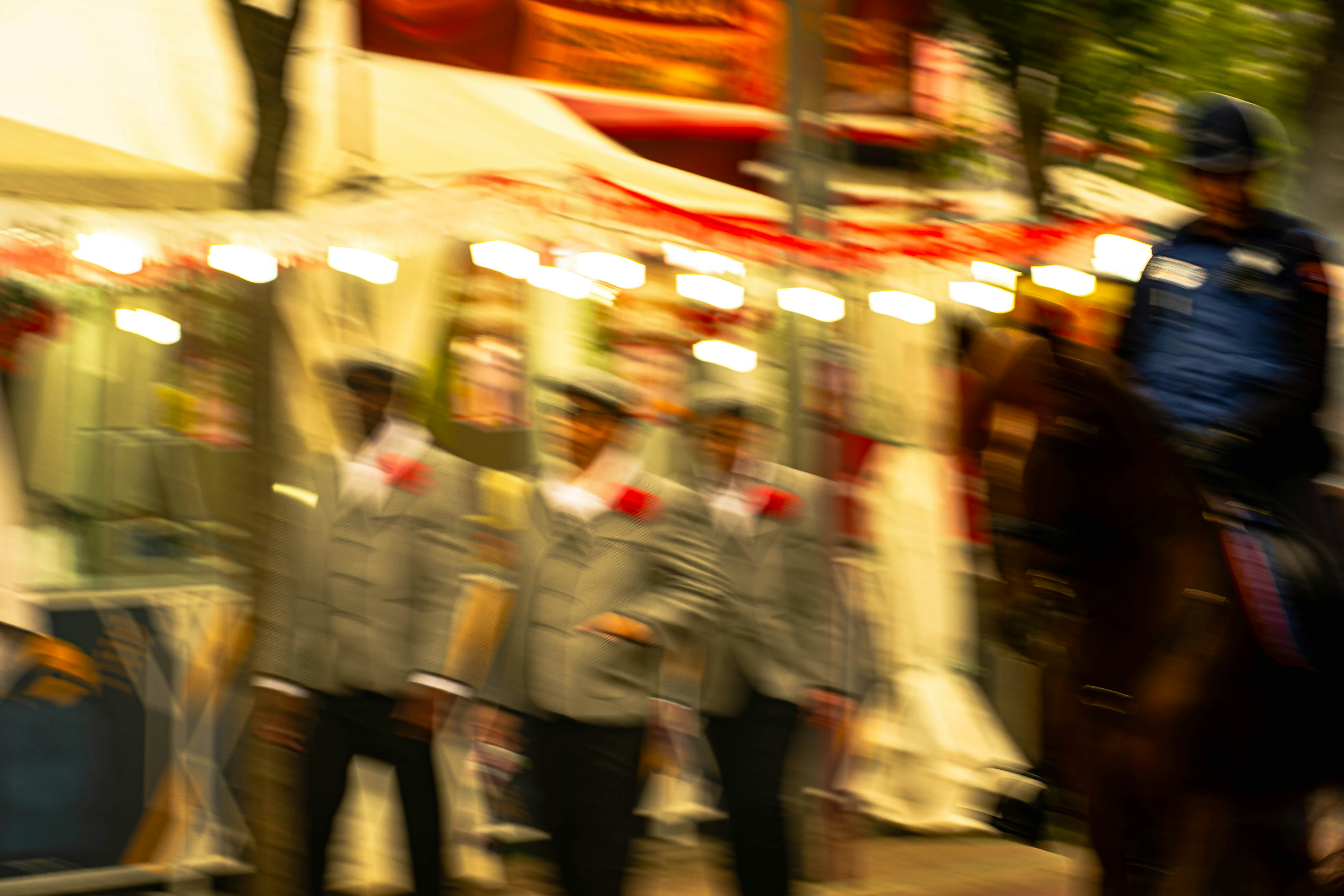 People are lined up near a mounted officer.