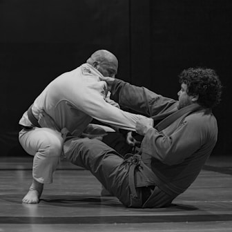 Two people grappling in a martial arts match.