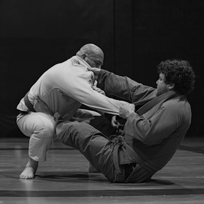Two people grappling in a martial arts match.