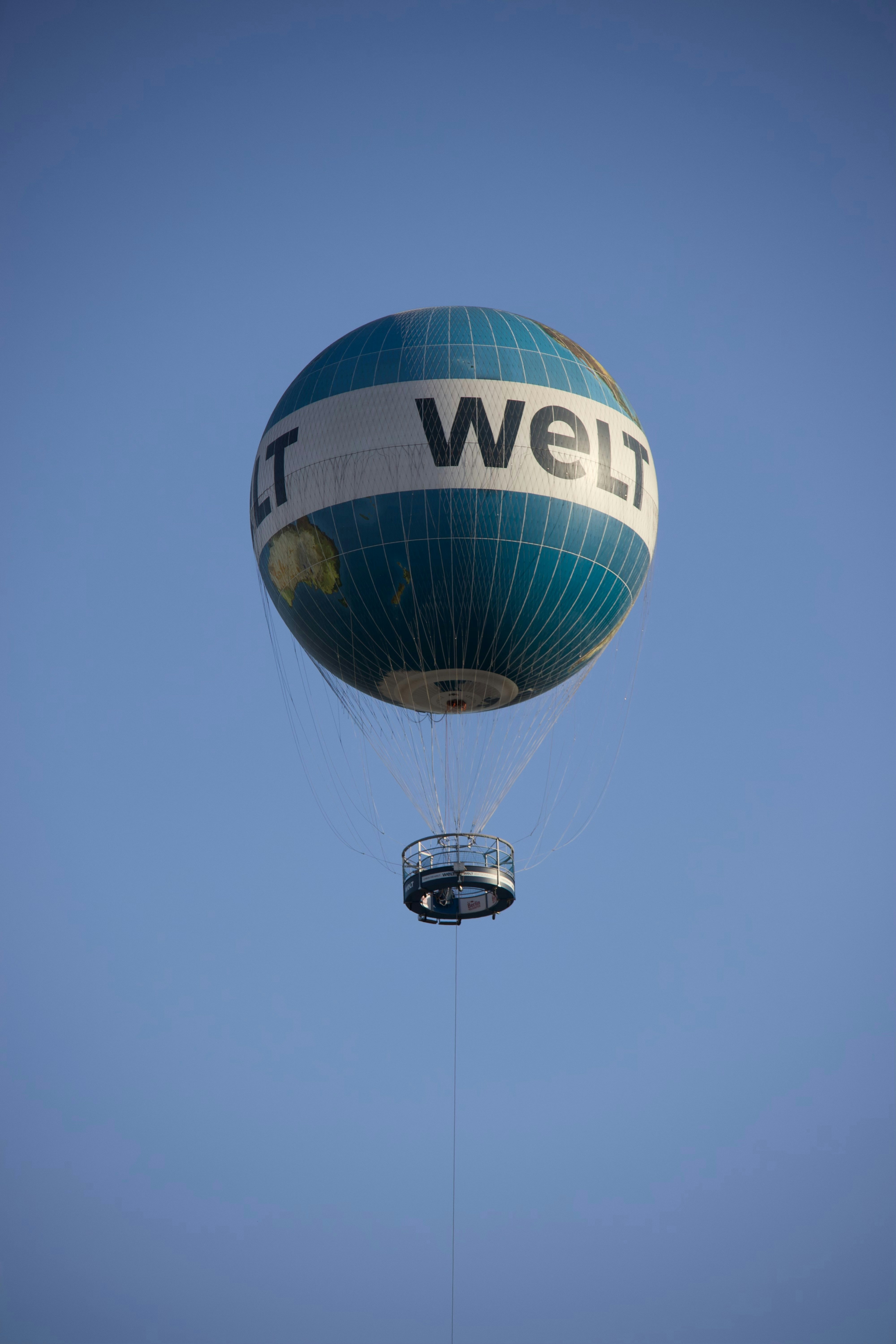 A welt balloon floats in the clear blue sky.