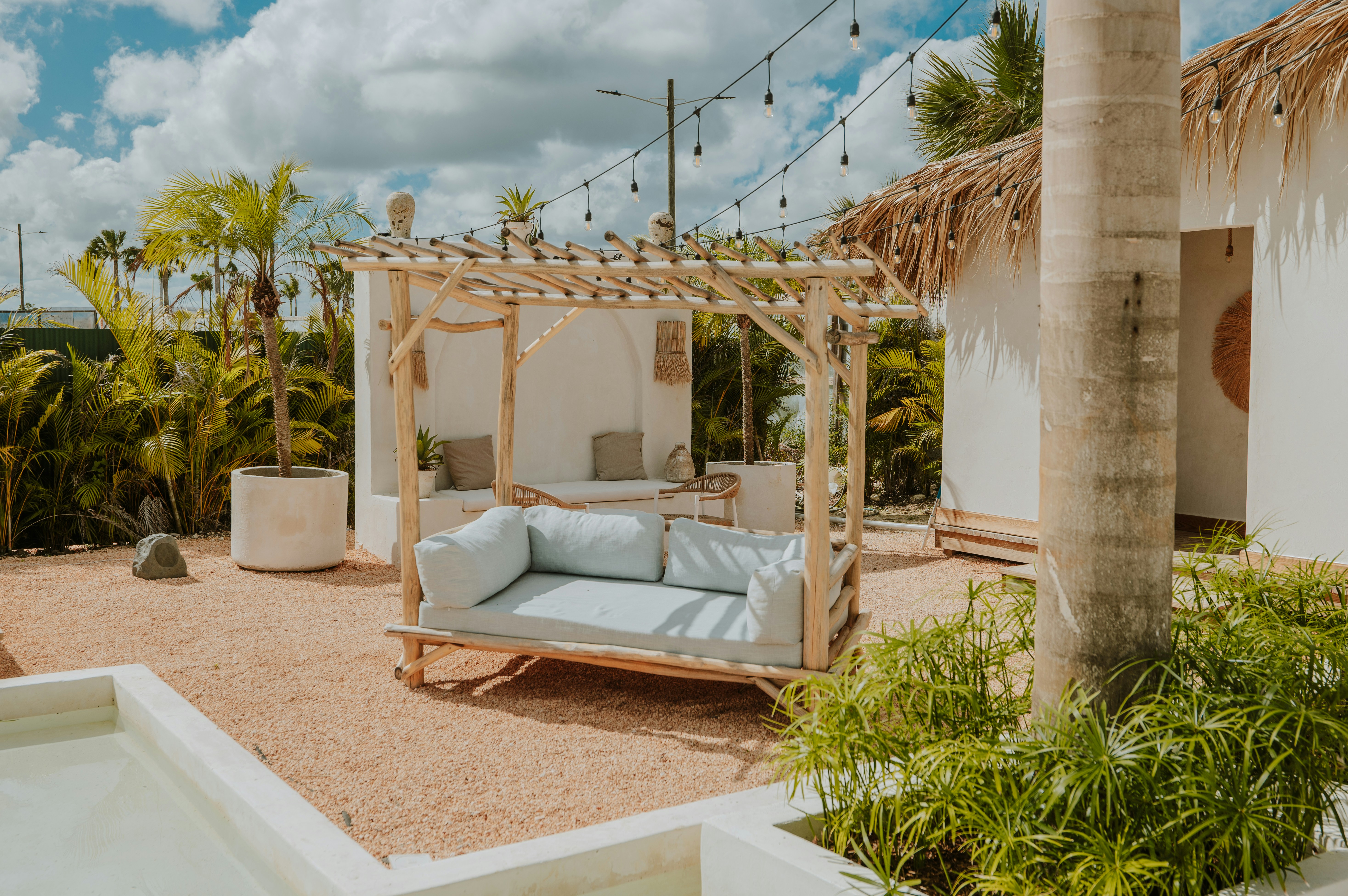A cozy outdoor lounge area under a pergola.