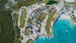 Aerial view of a golf course and beach resort.