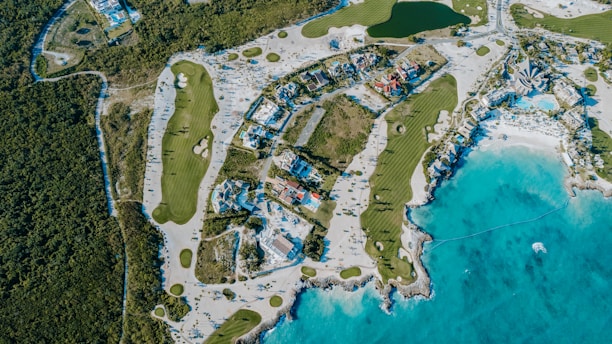 Aerial view of a golf course and beach resort.
