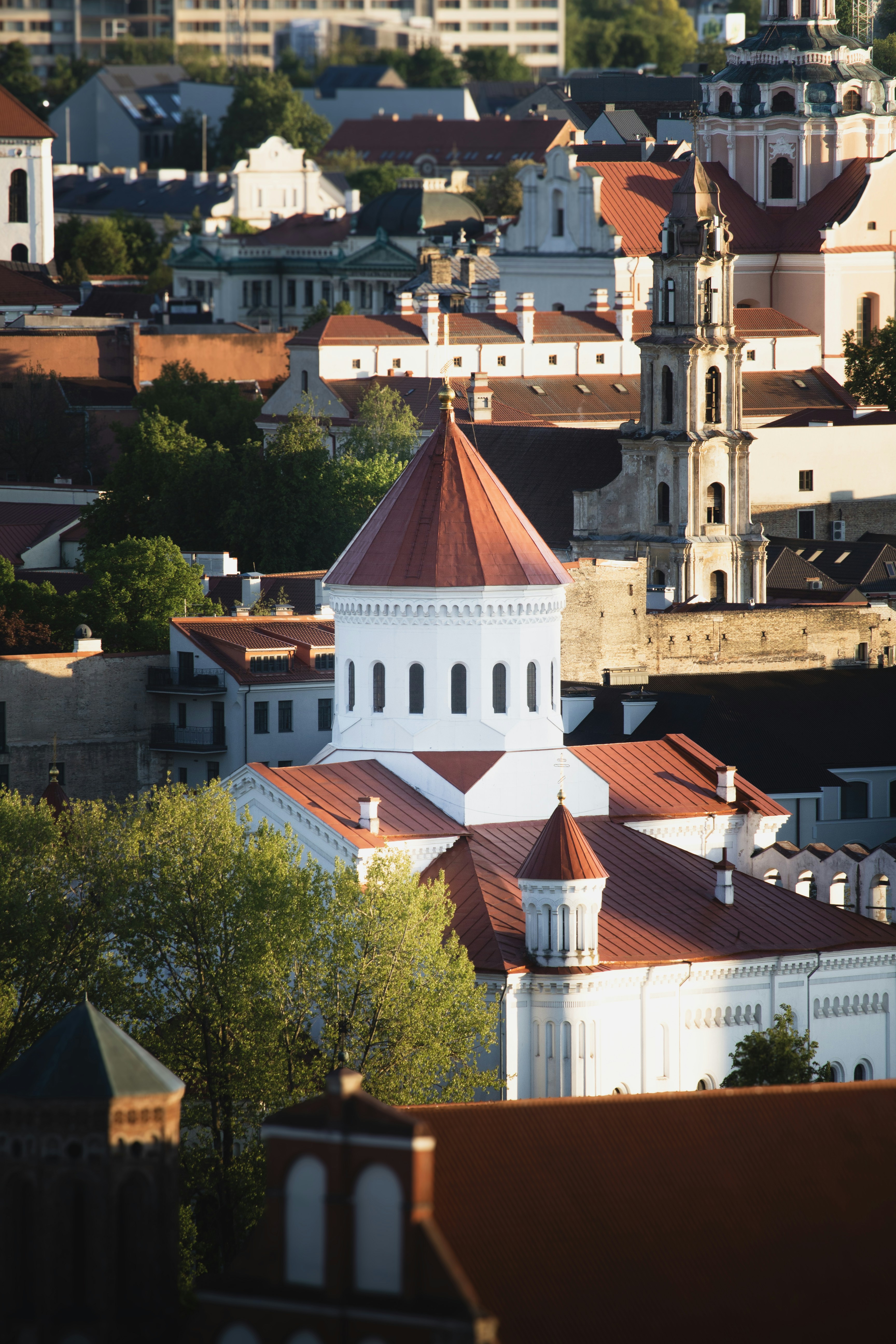 Cityscape featuring a church with a red roof.