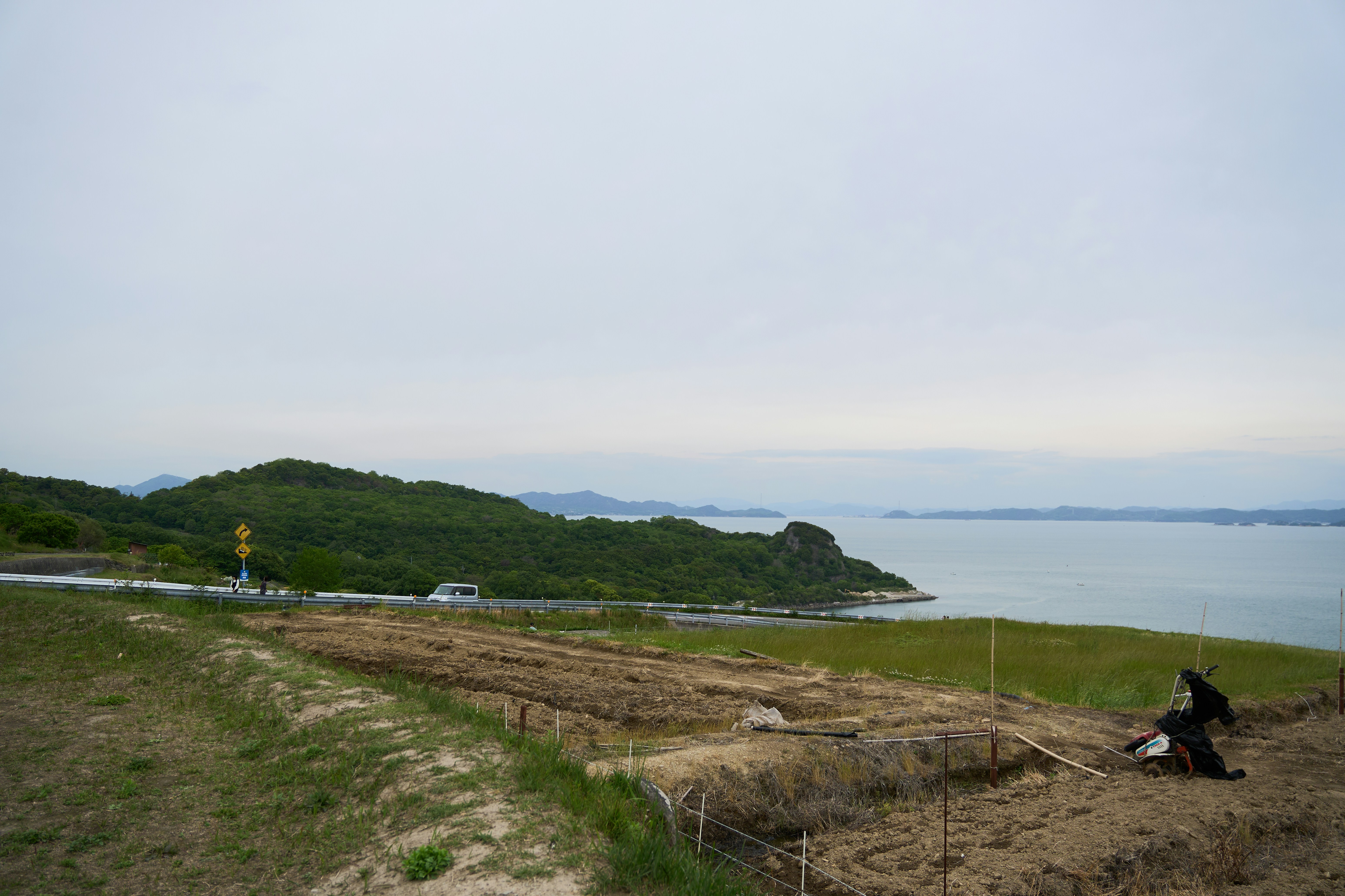 A road curves along the shoreline.