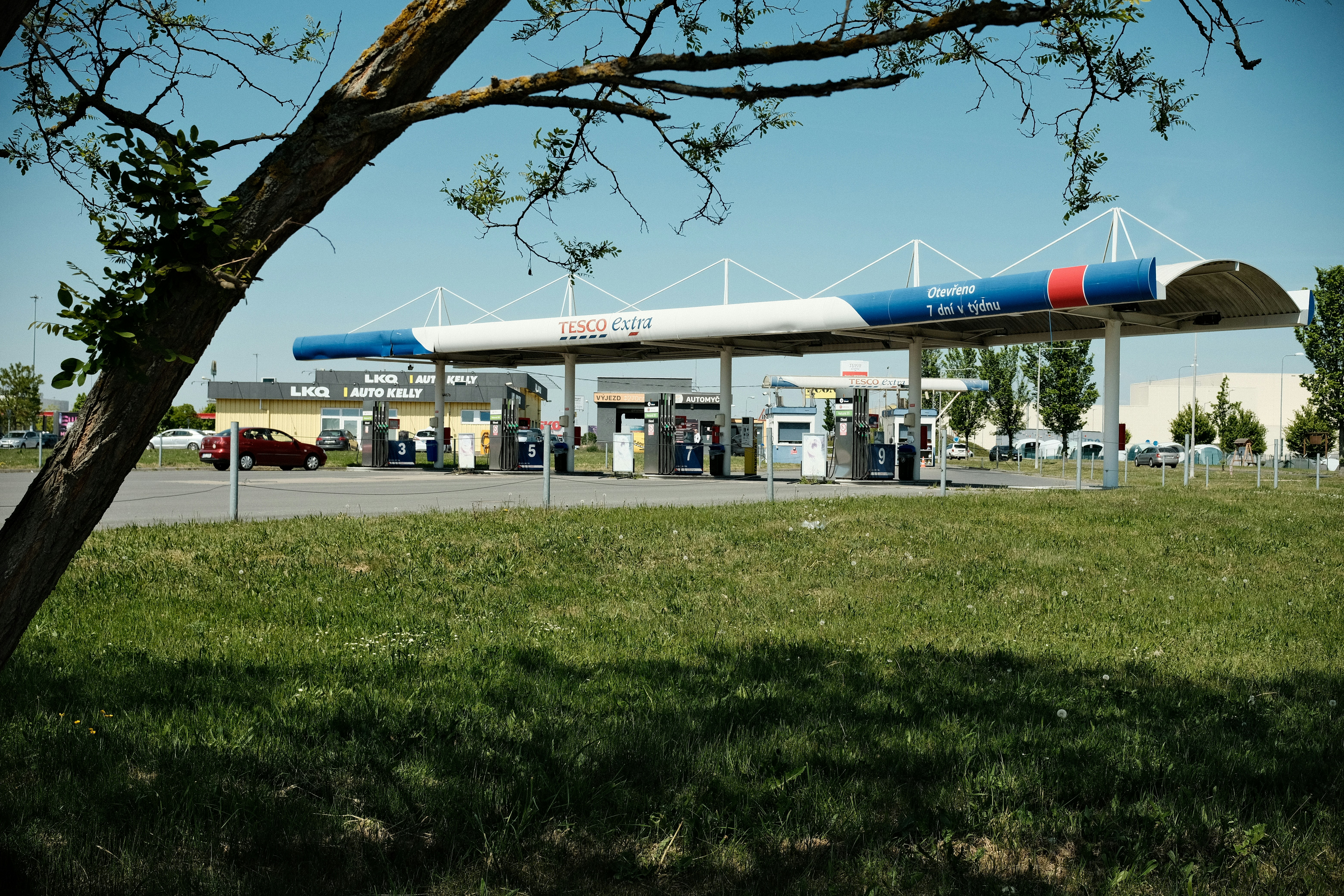 Gas station in the distance under a blue sky.