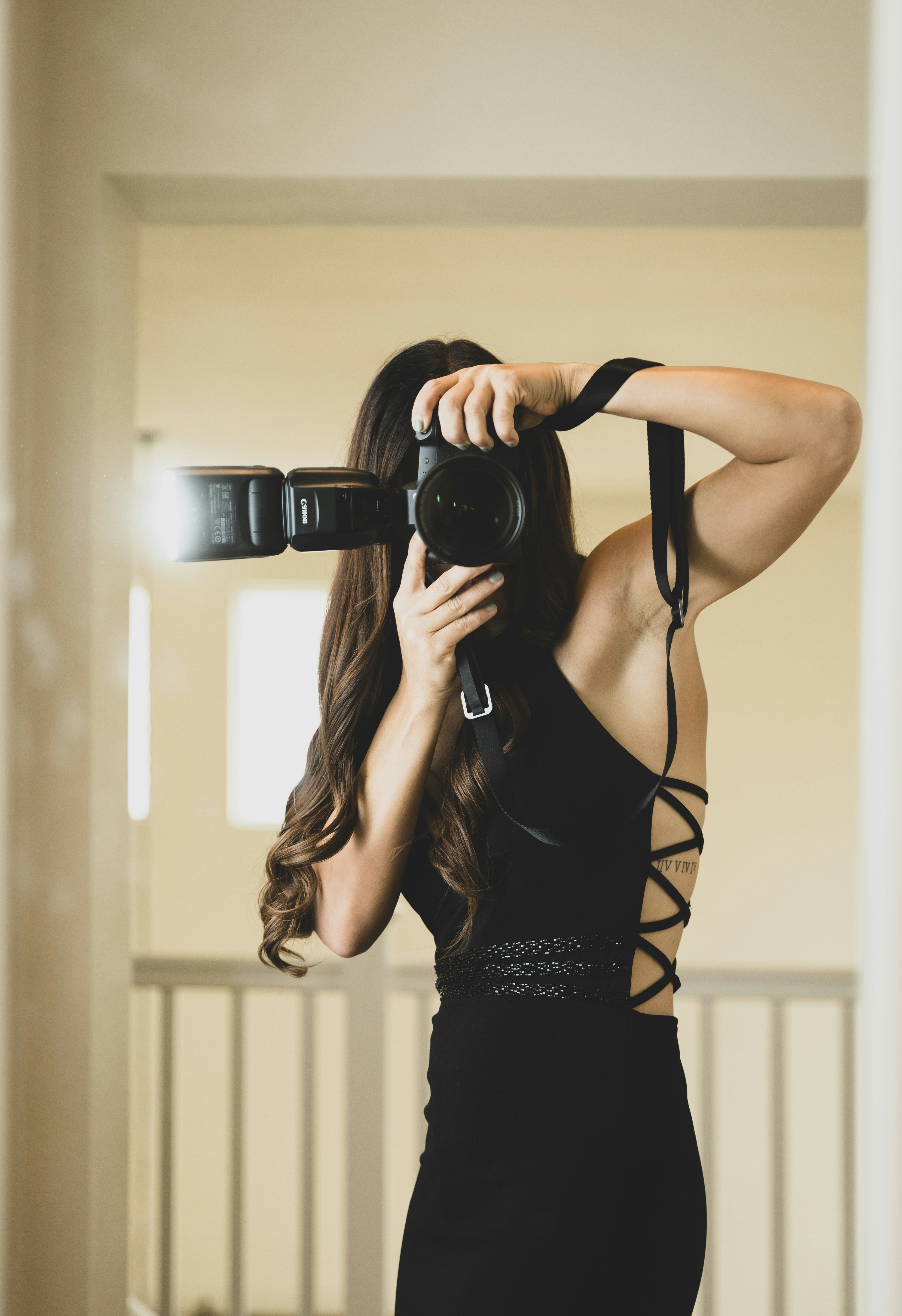A woman takes a photo with a camera.