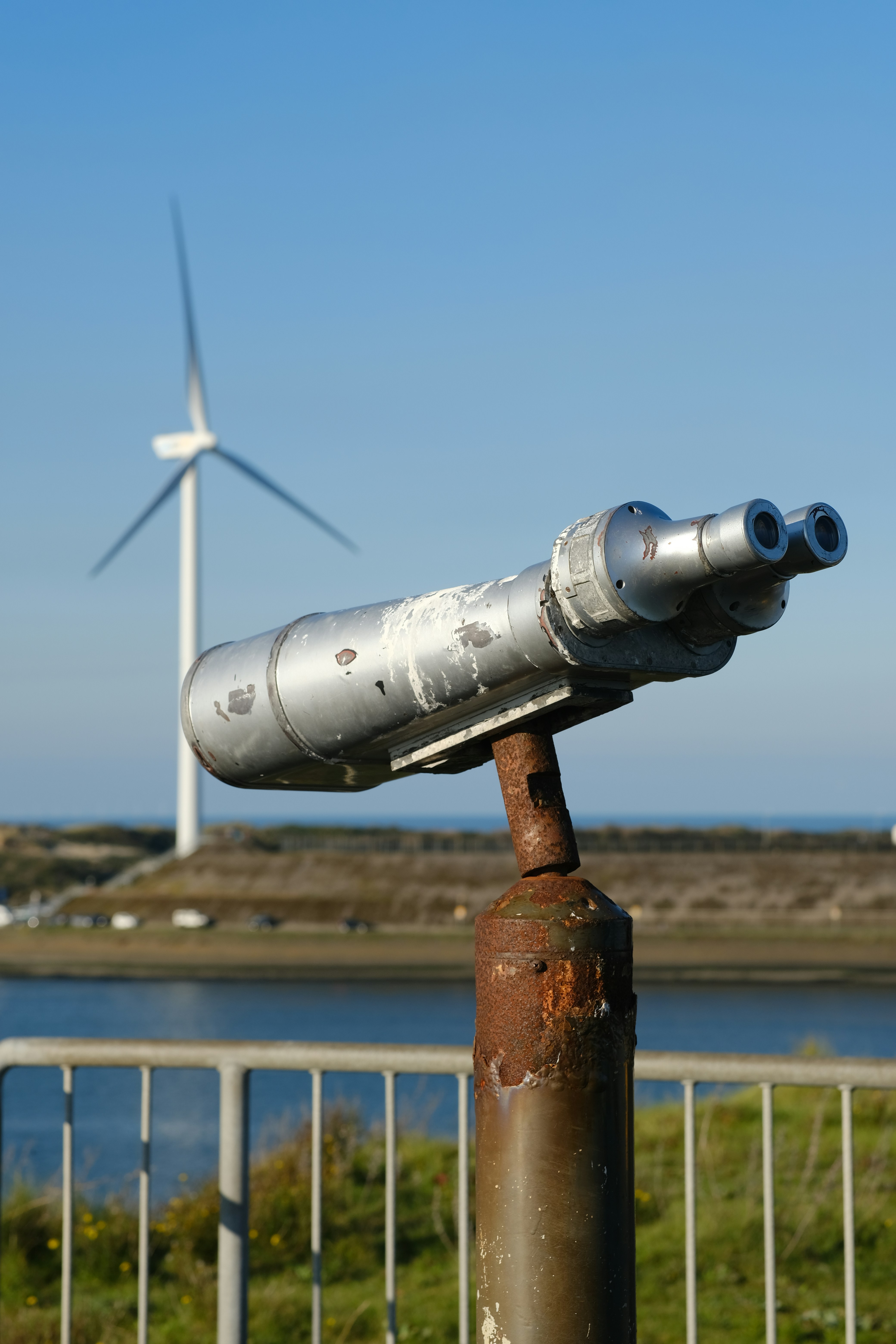 Binoculars offer a view near a wind turbine.