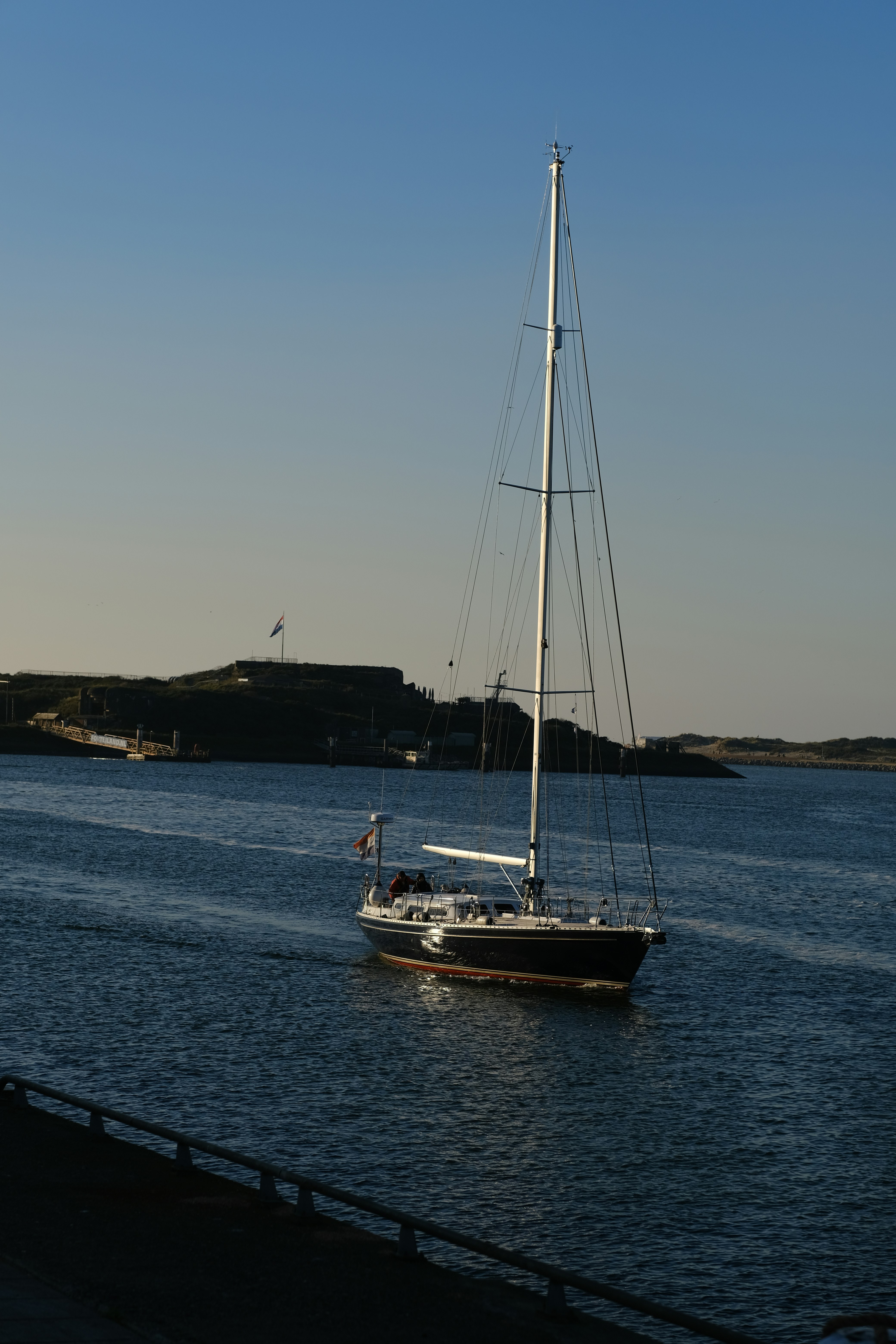 A sailboat glides through the water.