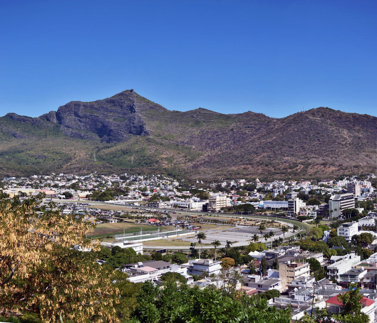 Port Louis and the Champ de Mars gathered below the mountains of Mauritius
