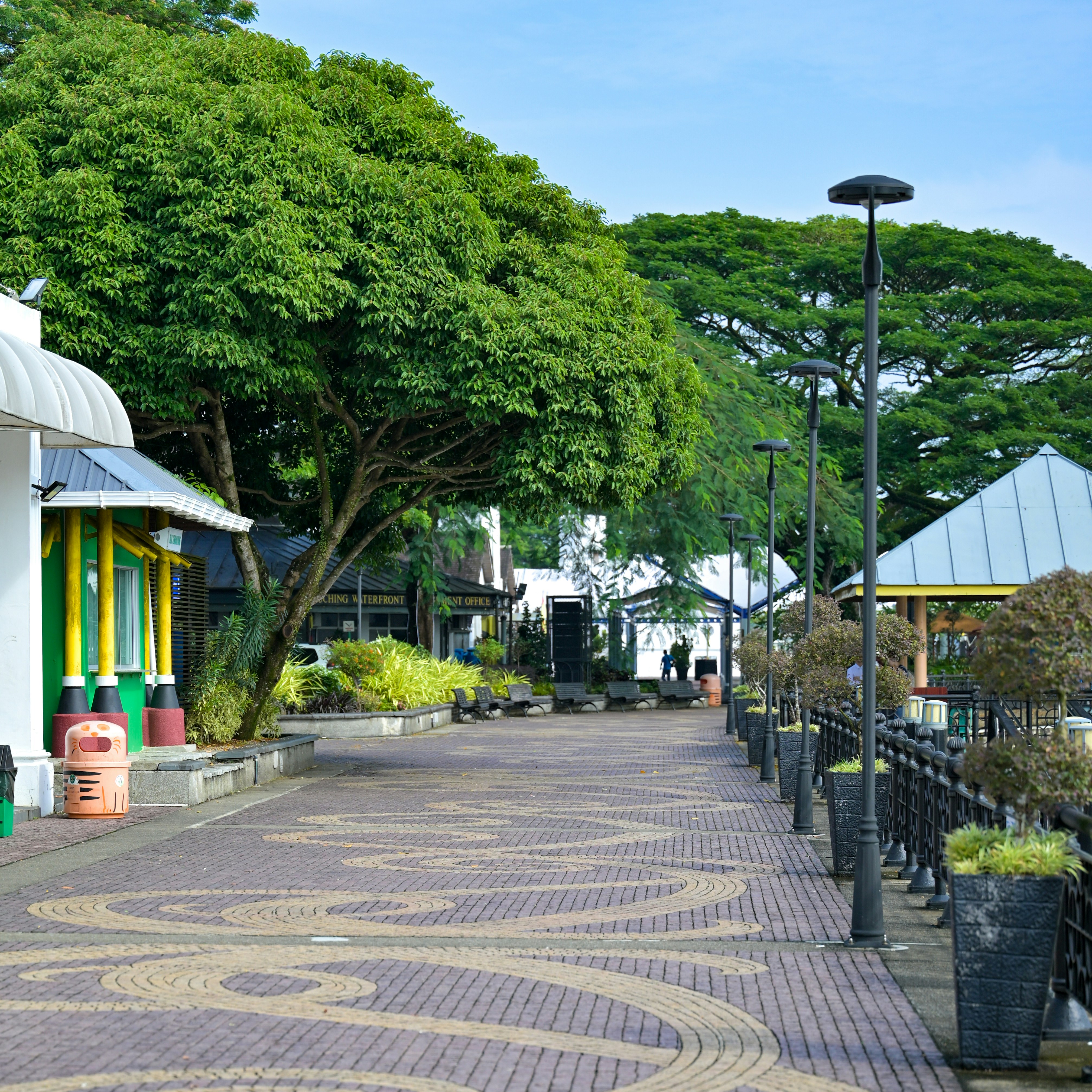 A beautiful pathway with trees and buildings.