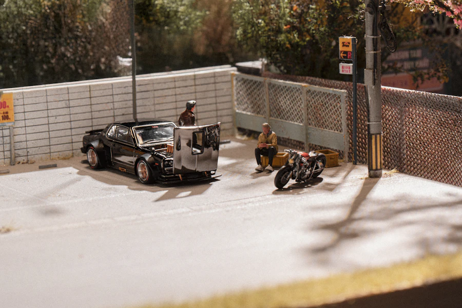 A street diorama with a car and a motorcycle