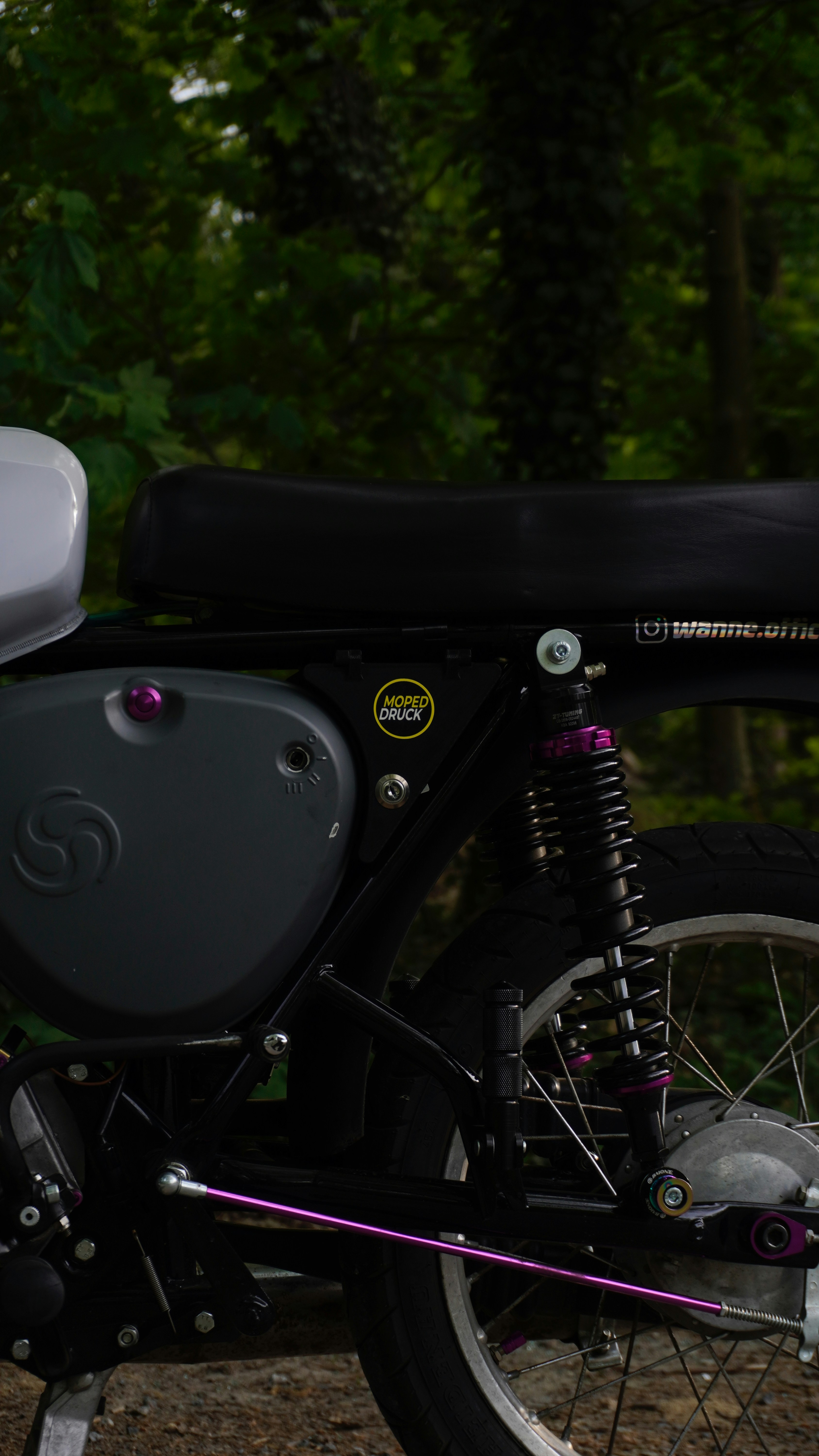 A motorcycle's side with purple accents.