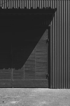 Shadows play on a building's textured exterior.