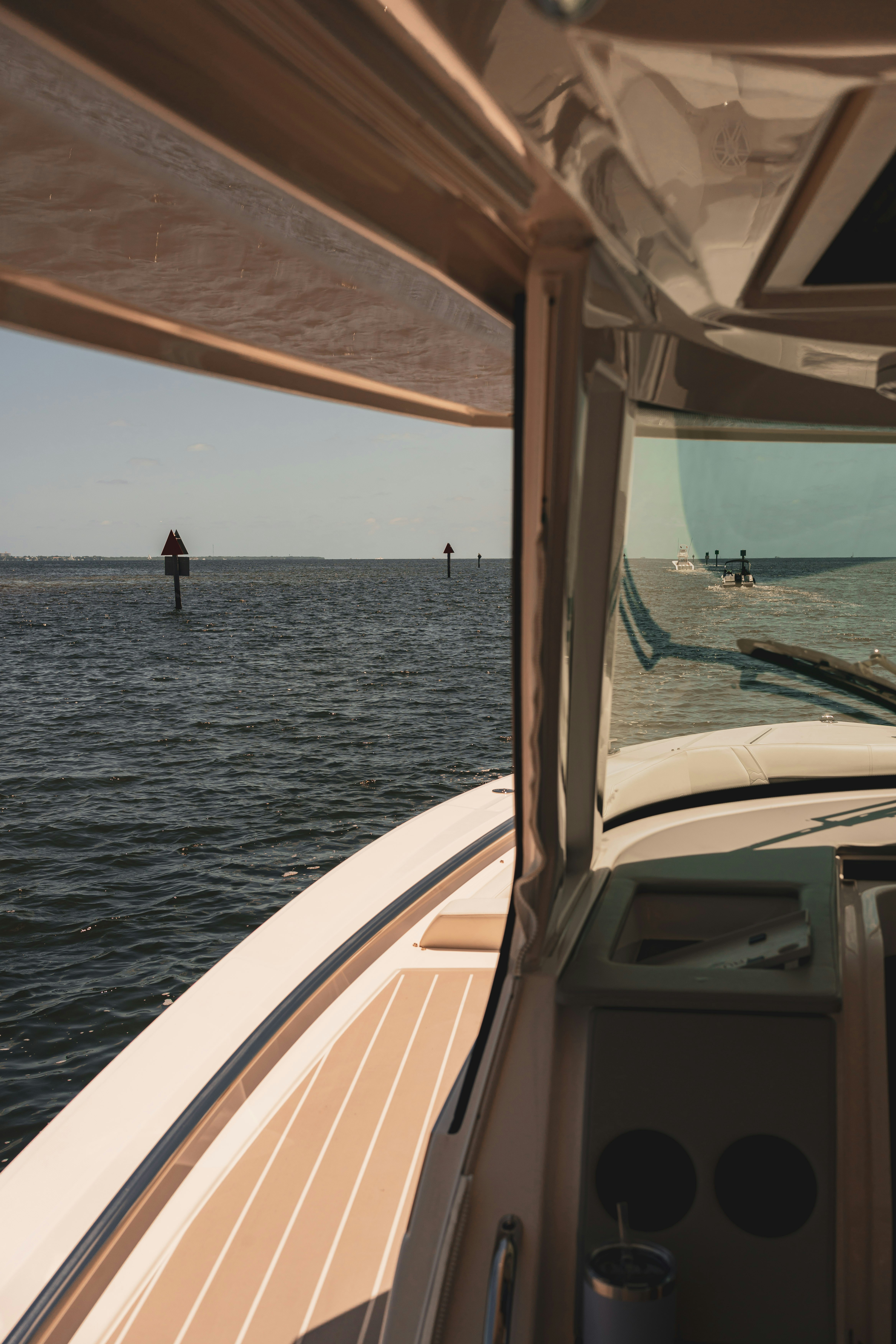 A boat navigates the water on a sunny day.