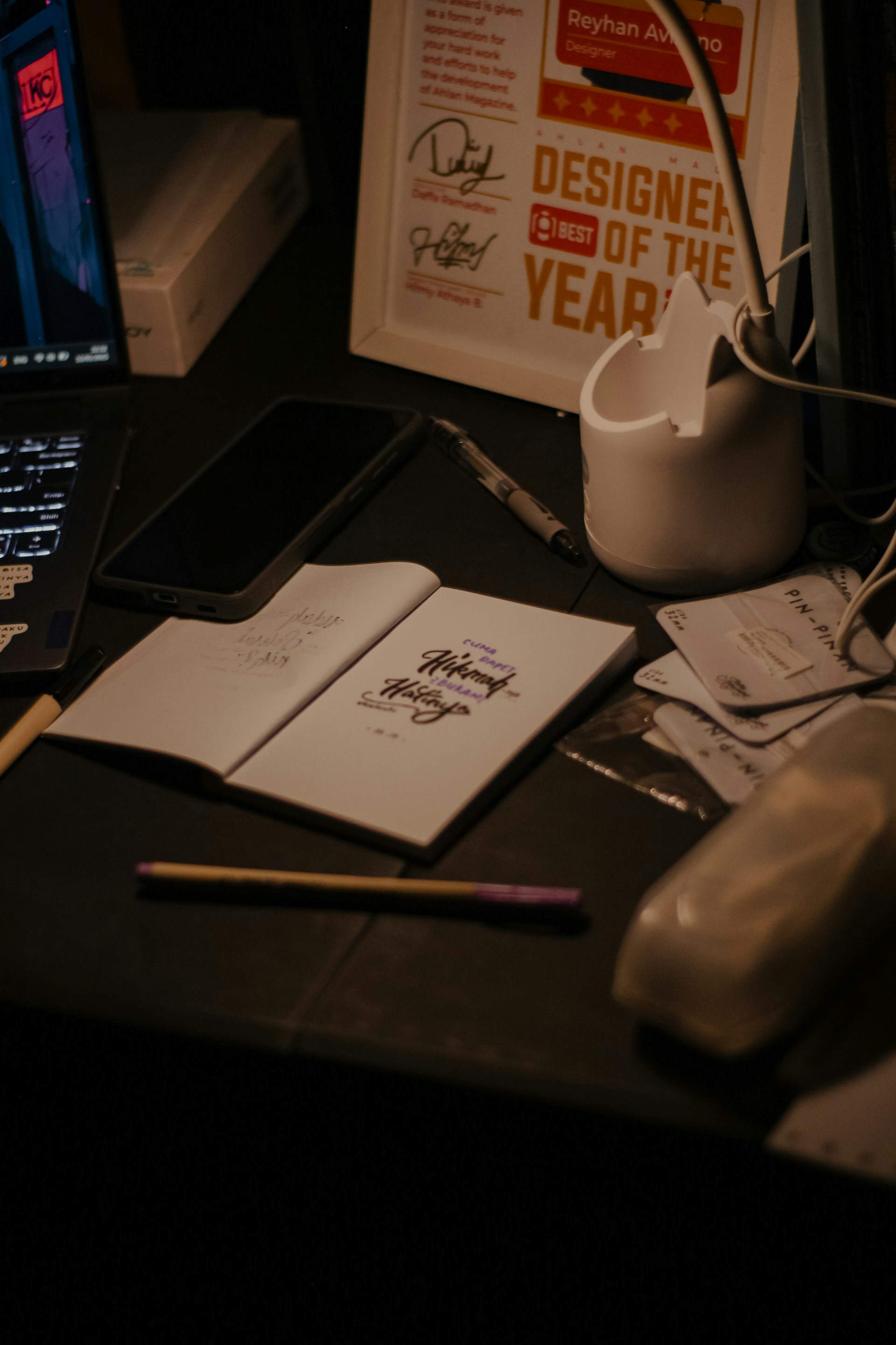 A cluttered desk with design tools and notes.