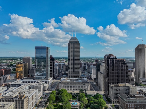 Indianapolis skyline featuring tall buildings and blue sky.