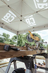 A miter saw and tools are ready for construction.