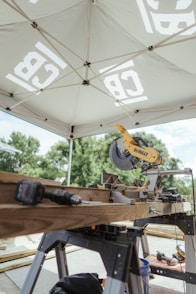 A miter saw and tools are ready for construction.