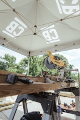 A miter saw and tools are ready for construction.