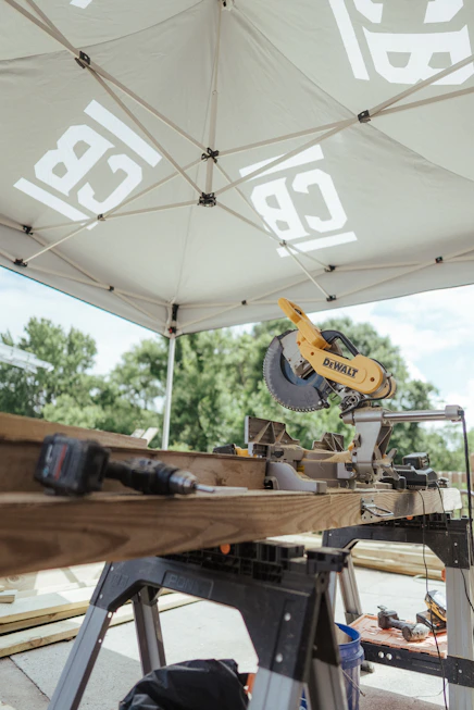 A miter saw and tools are ready for construction.