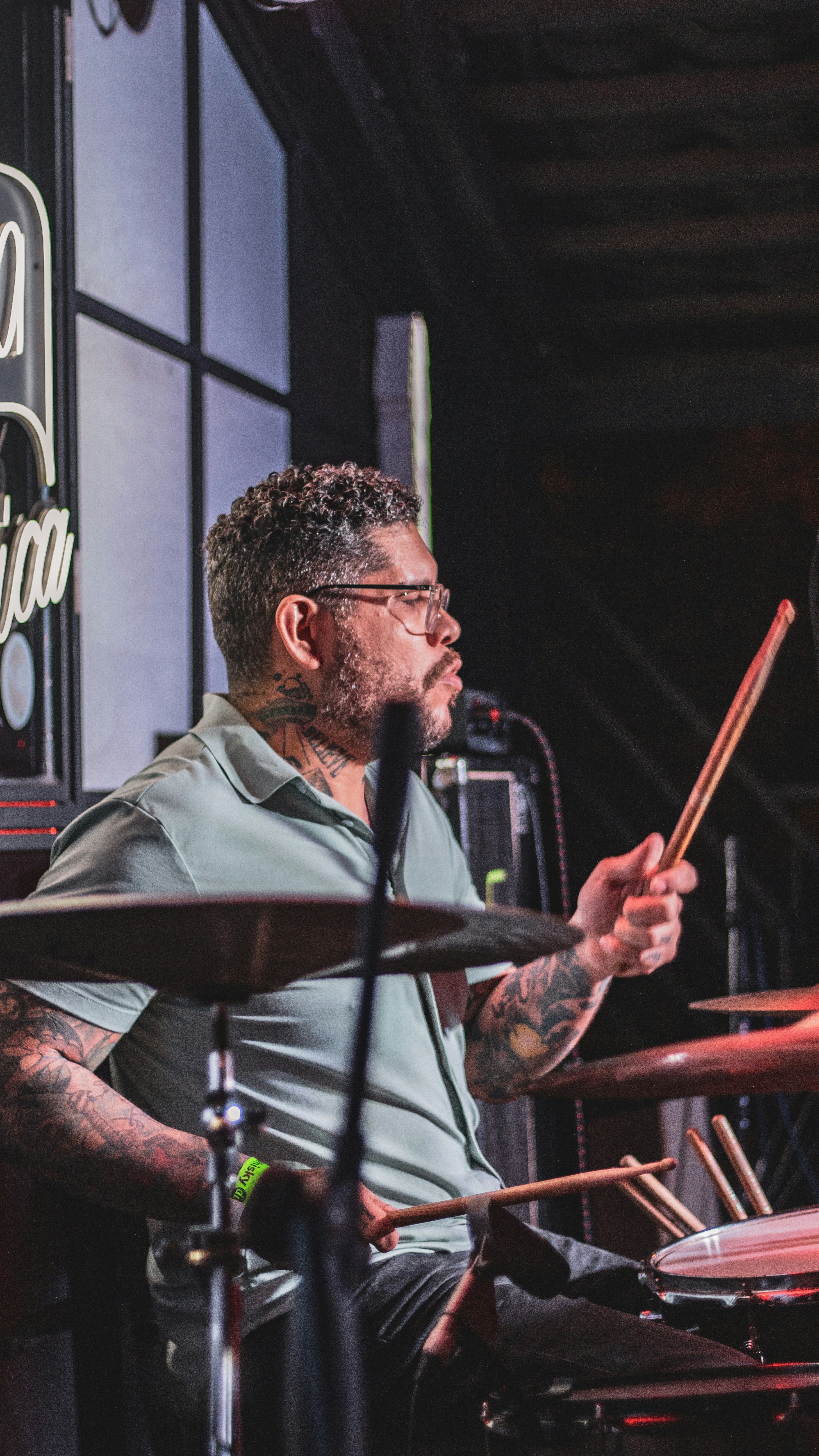 A drummer is playing with drumsticks.