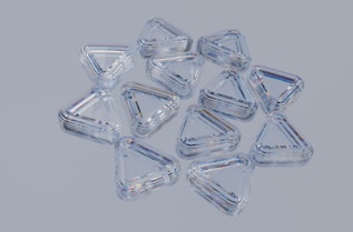 Clear, triangular, plastic containers arranged together.