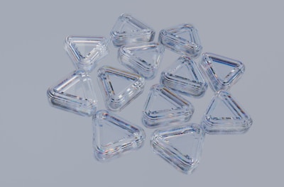 Clear, triangular, plastic containers arranged together.