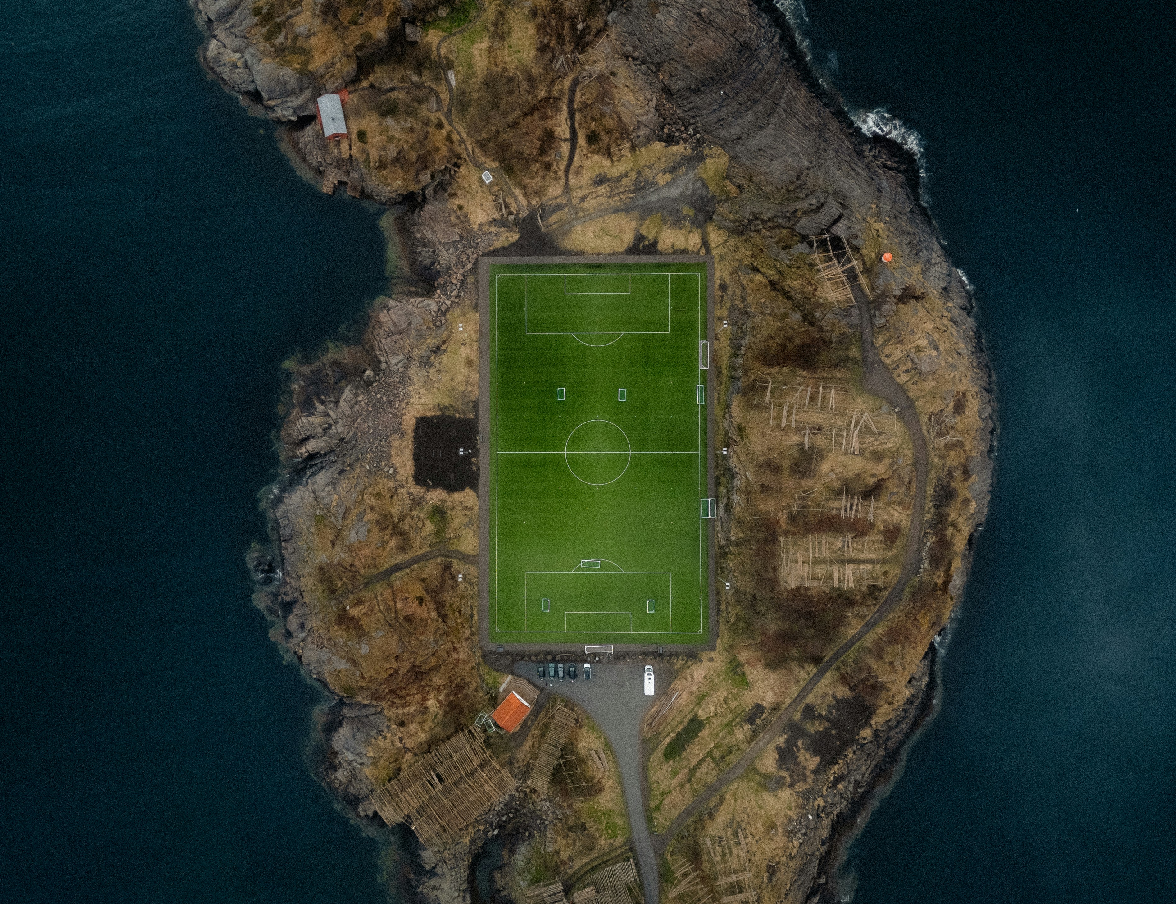 A soccer field sits on a tiny island.