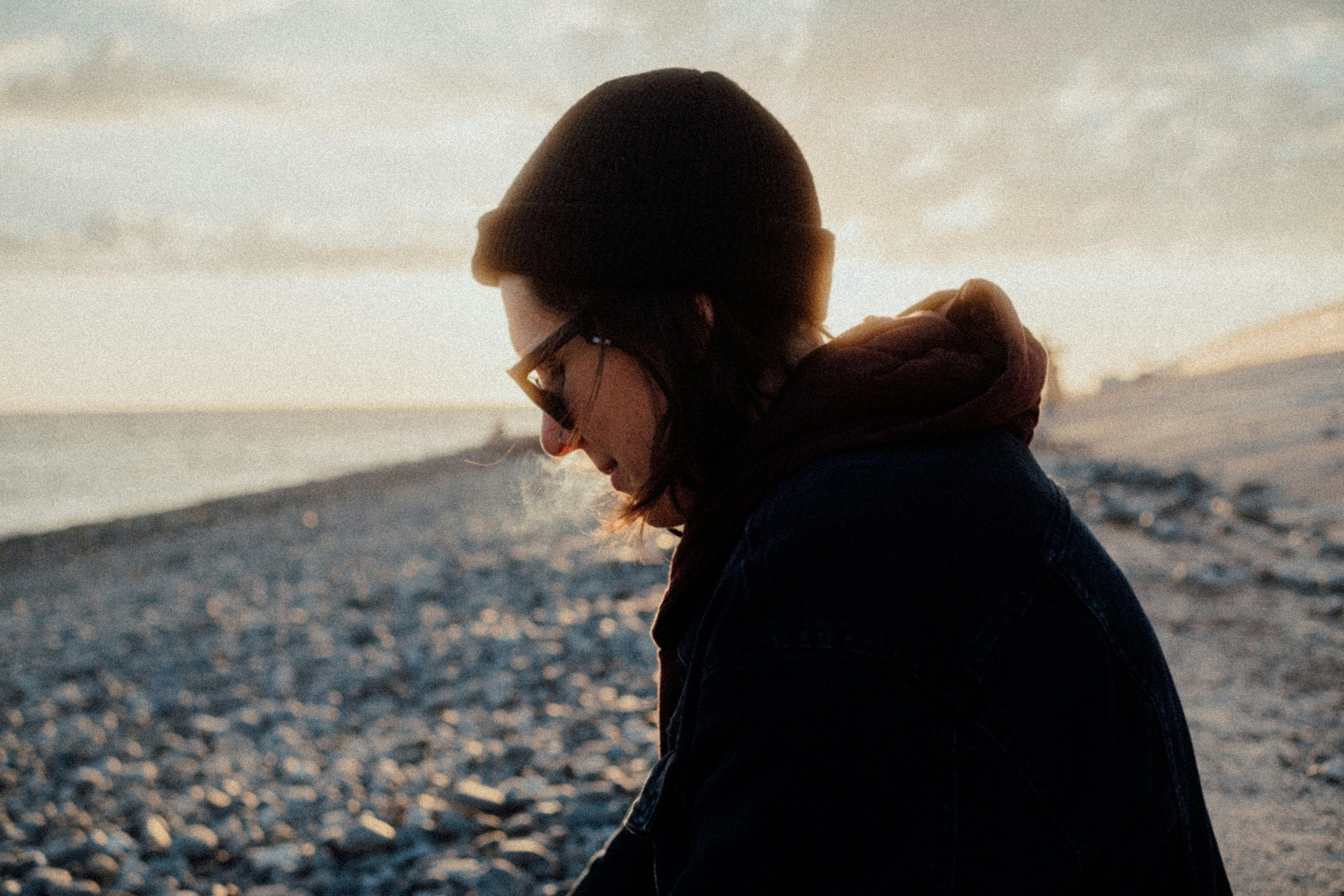 Person looking down at beach during sunset