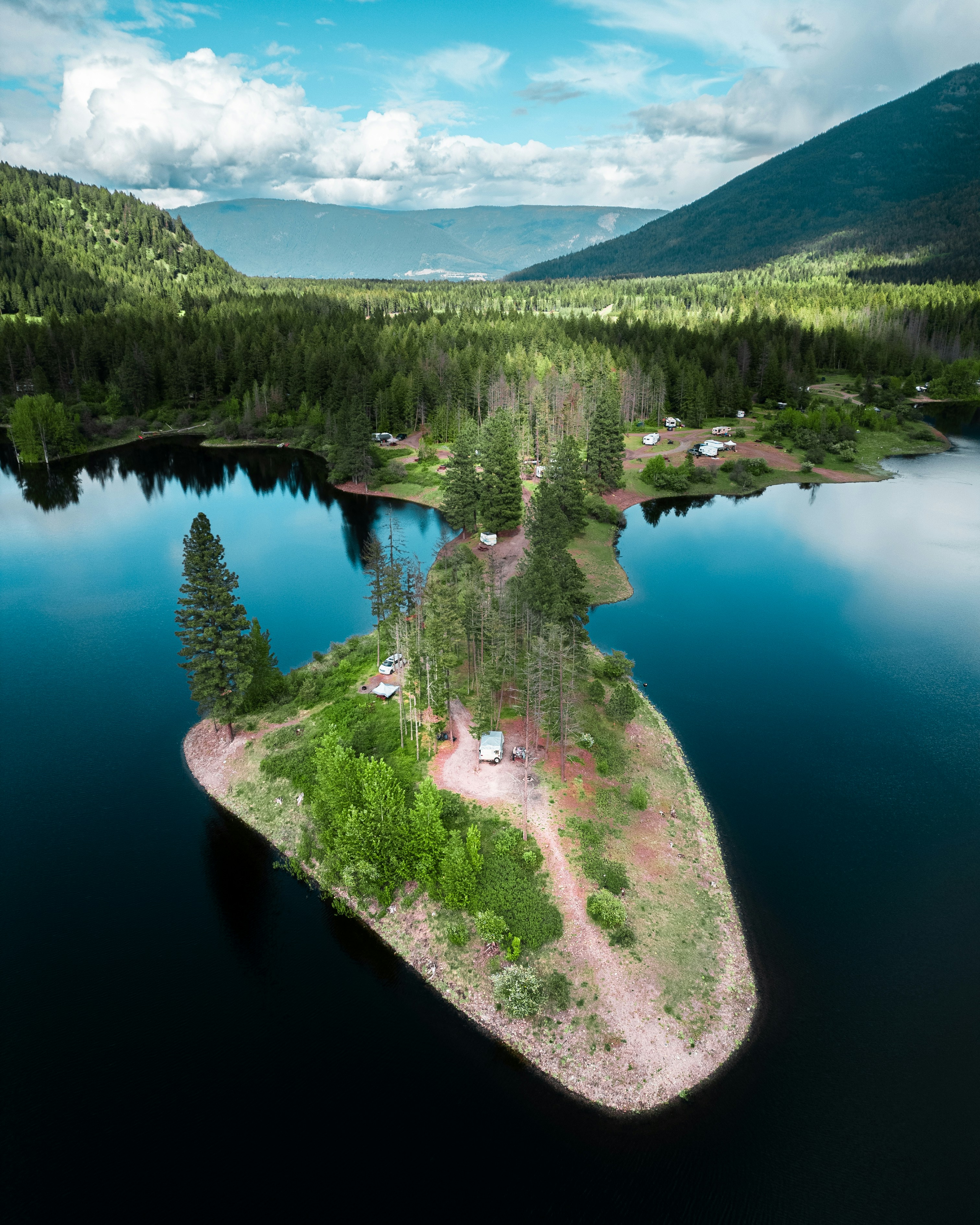 Island surrounded by water and mountainous landscape.