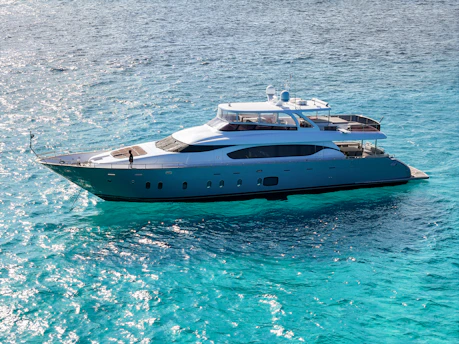 A luxurious yacht is floating on blue water.