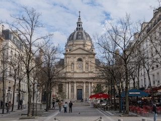A beautiful building stands between trees.