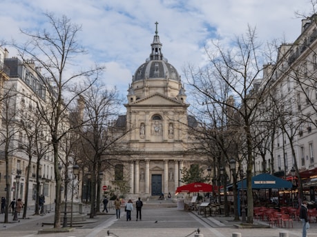 A beautiful building stands between trees.