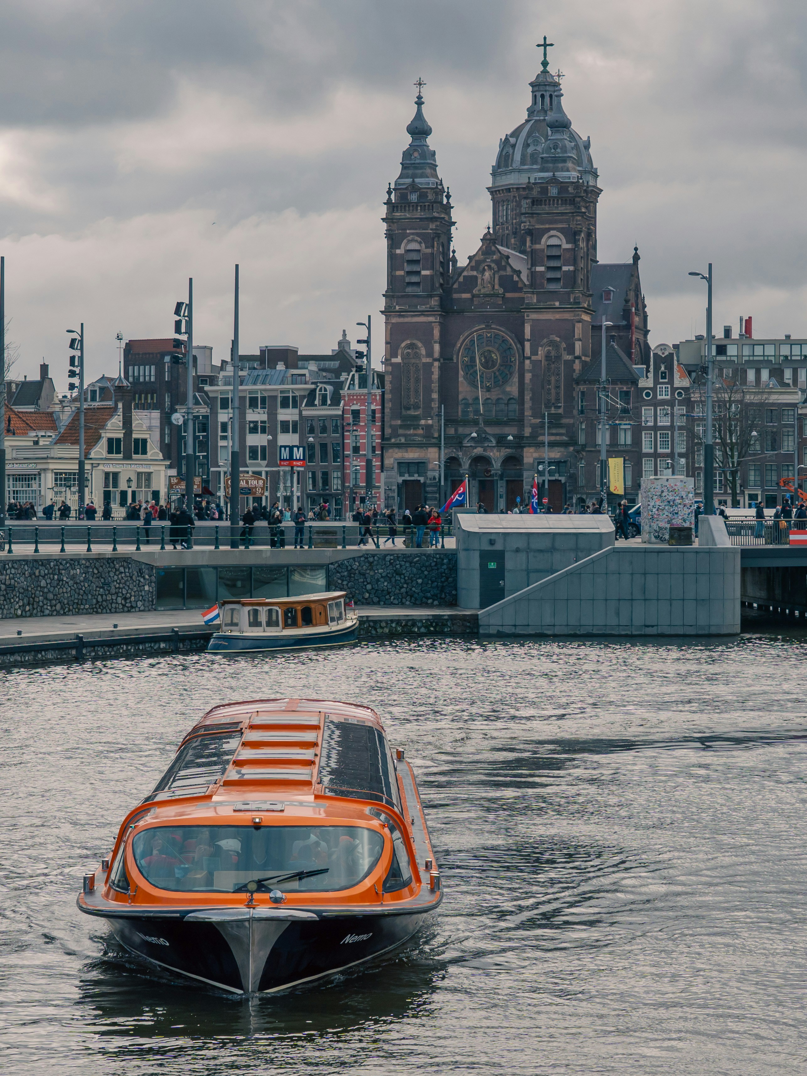 A boat glides on the water, with a church.