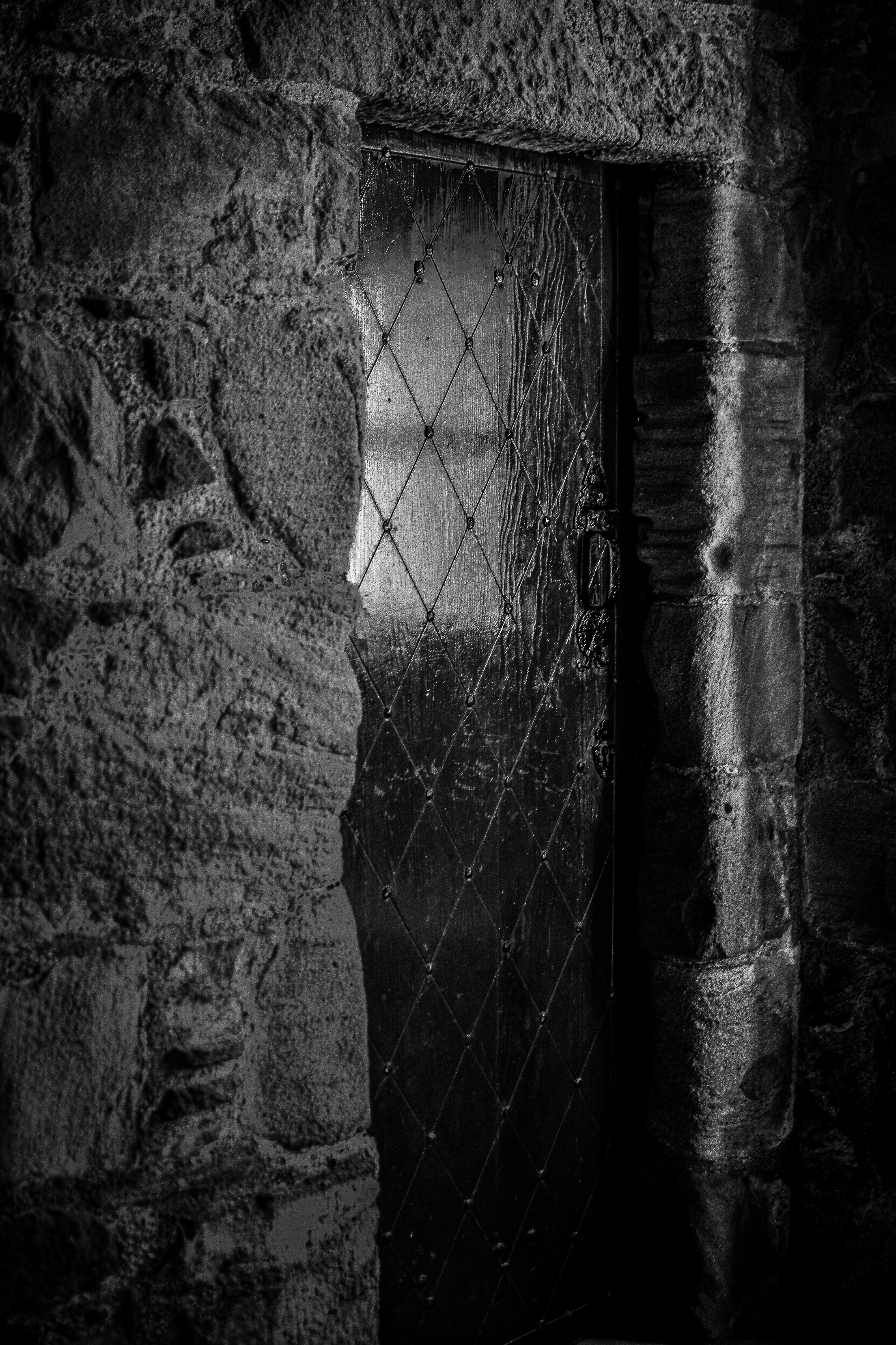 A window peeks through a stone doorway.
