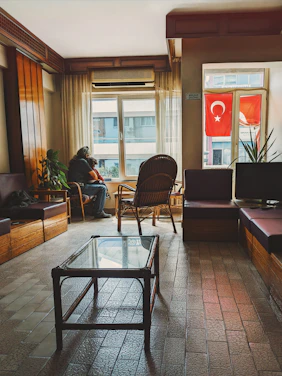 A person is sitting in a room with a turkish flag