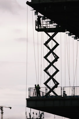 Construction workers are working on a high platform