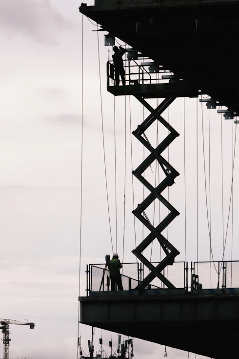 Construction workers are working on a high platform