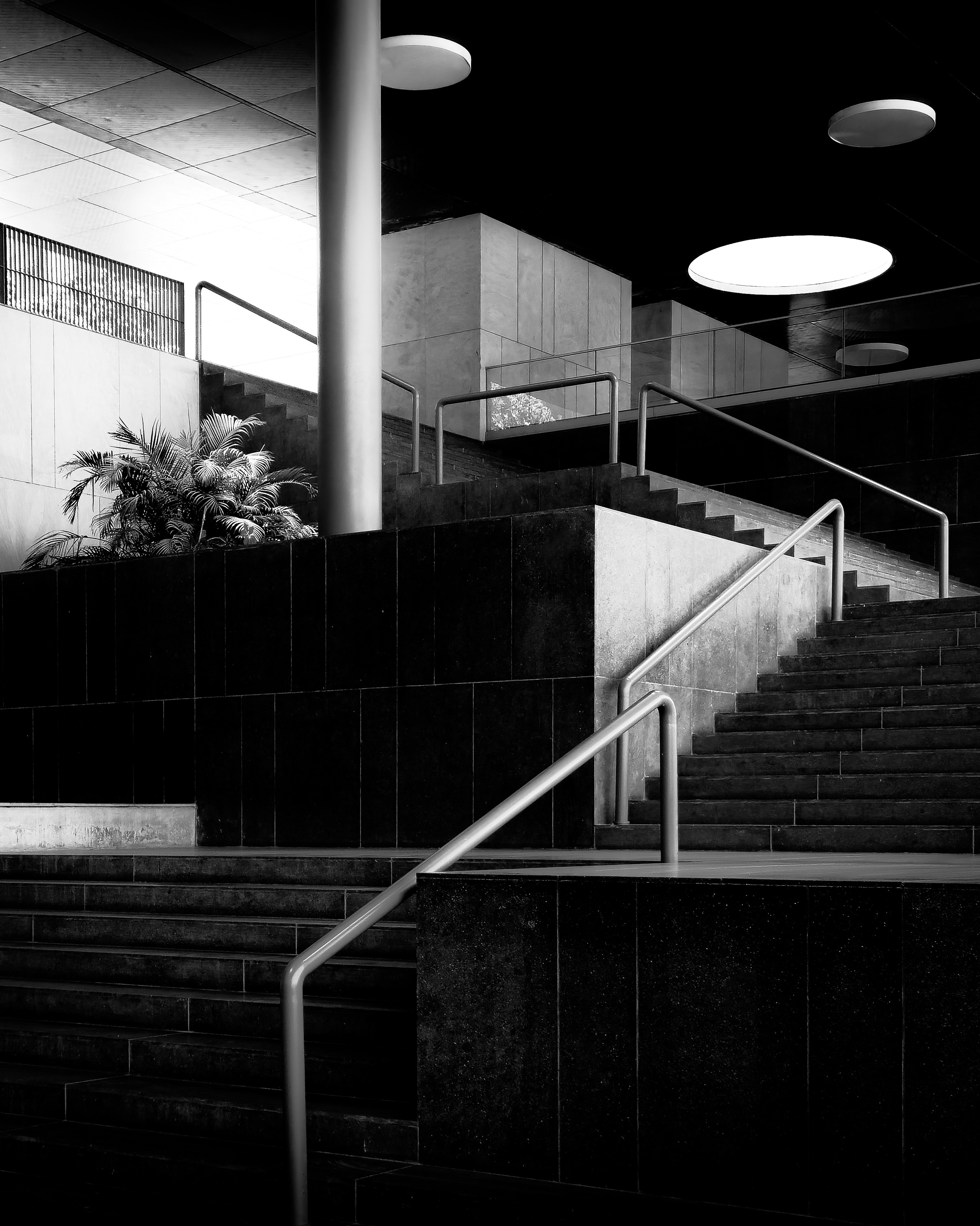 Architectural design with stairs, handrails, and lights.