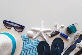 Beach essentials are laid out on a surface.