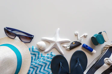 Beach essentials are laid out on a surface.