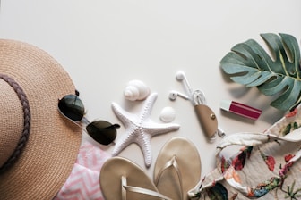 Summer essentials arranged on a white surface.