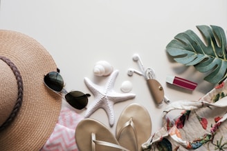 Summer essentials arranged on a white surface.