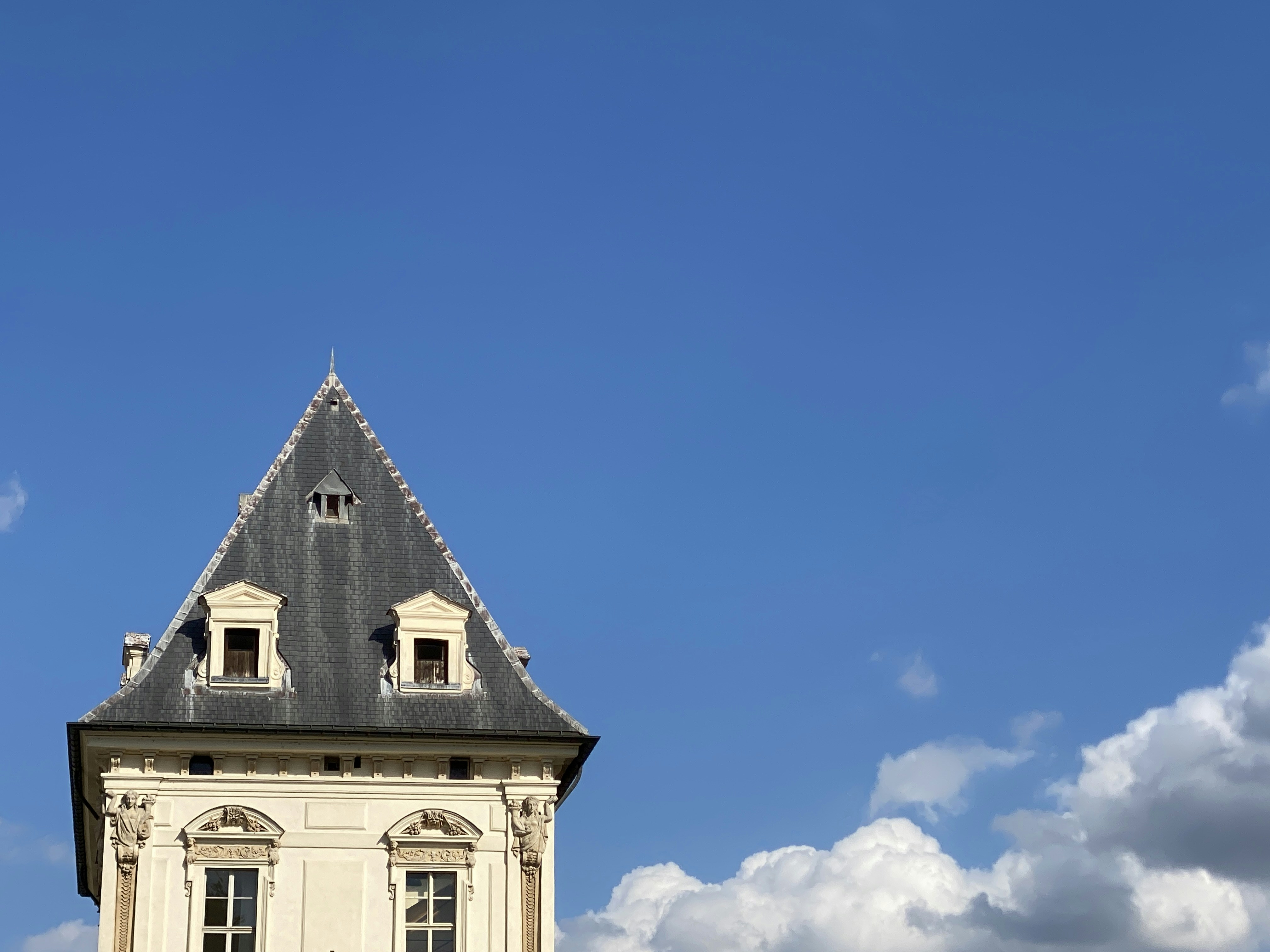 A building's roof against a clear blue sky.