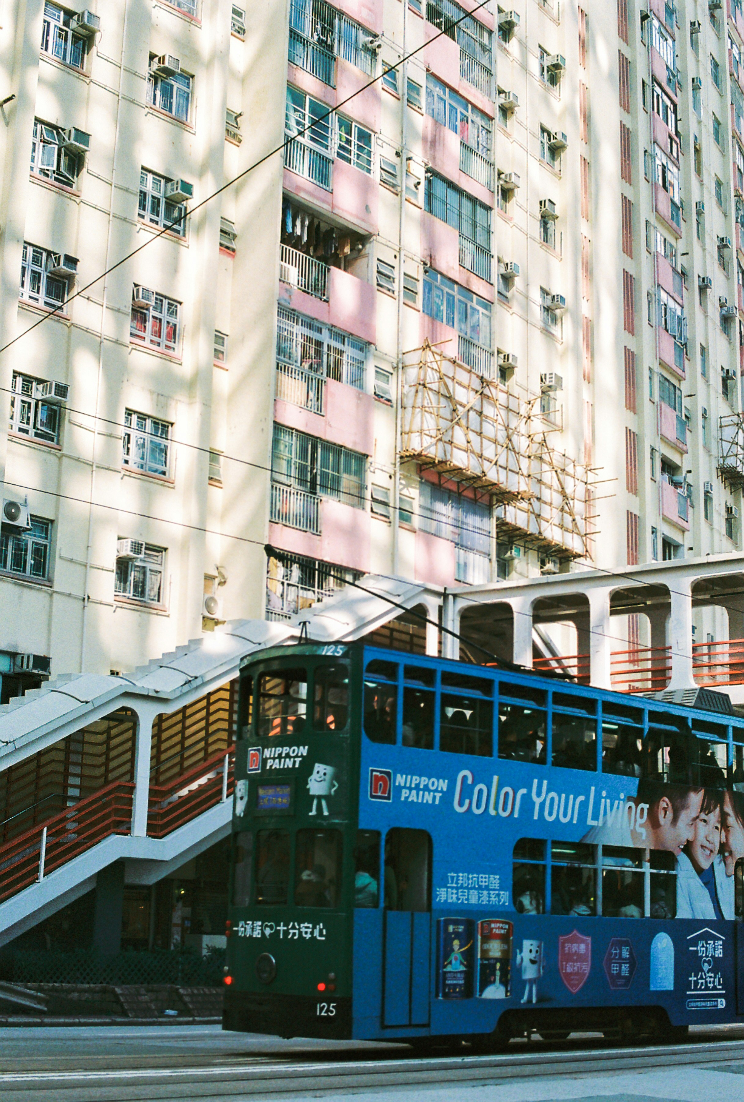 A double-decker tram travels through a city.