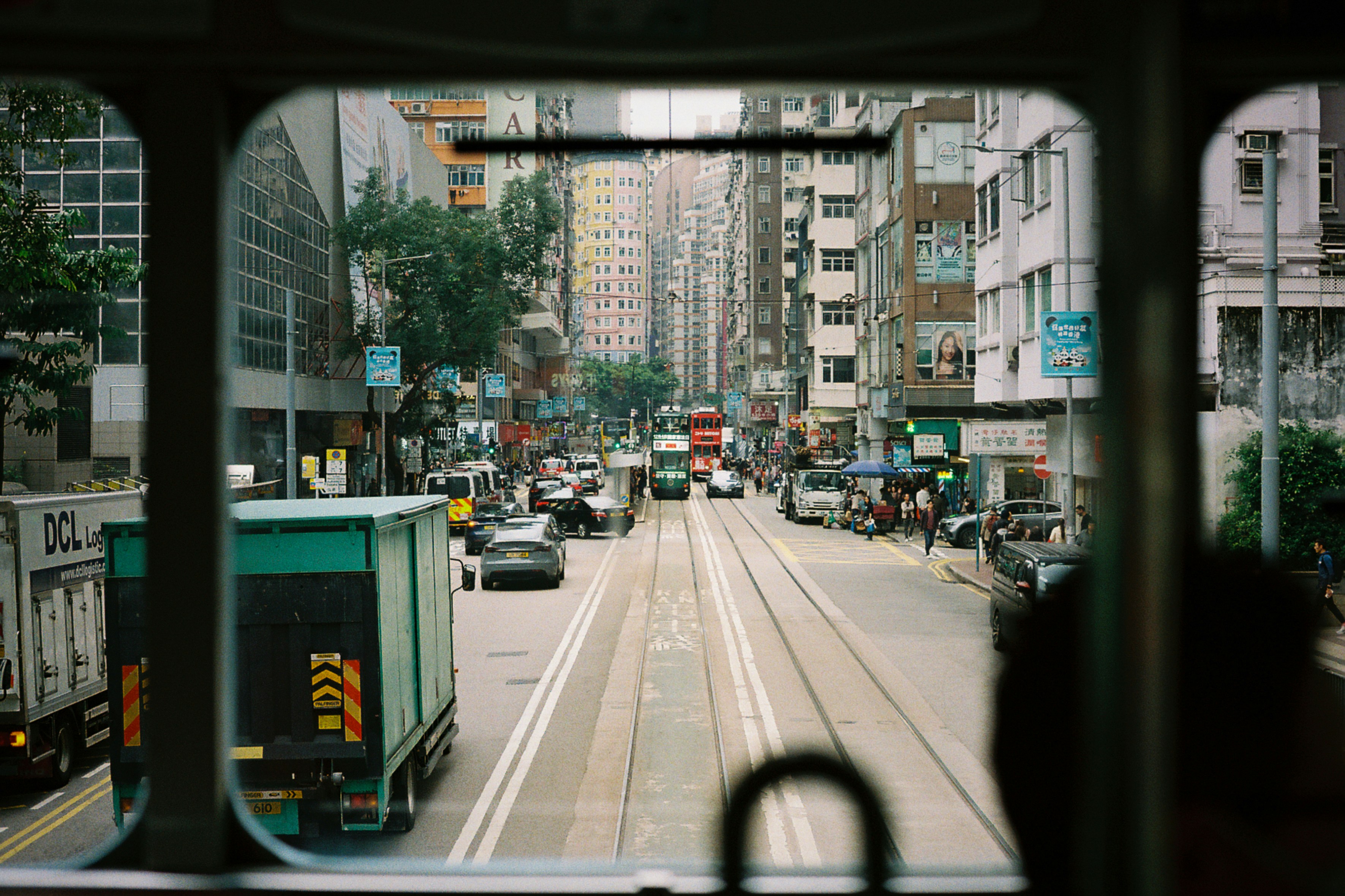Looking out of a tram at a busy street.